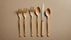 A comparison of polished wooden cutlery and bagasse cutlery on a neutral background